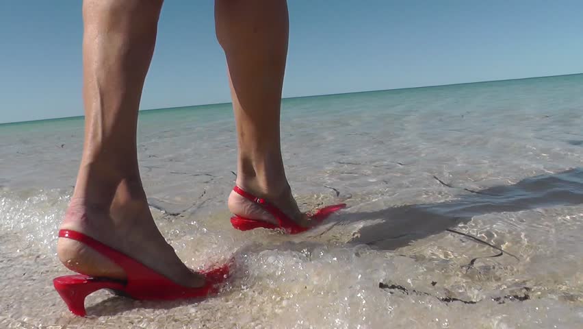 Attractive Woman Walking In High Heel Shoes To Beach At Summer Sunny Day Blue Sky Slow Motion 