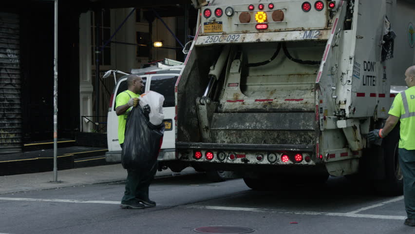 NEW YORK - MAY 17, 2015: Sanitation Worker Waving, Guiding, Leading