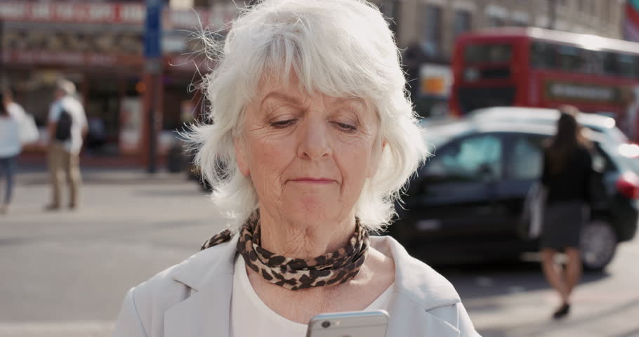 Slow Motion Portrait Of Happy Mature Old Woman Using Smart Phone In