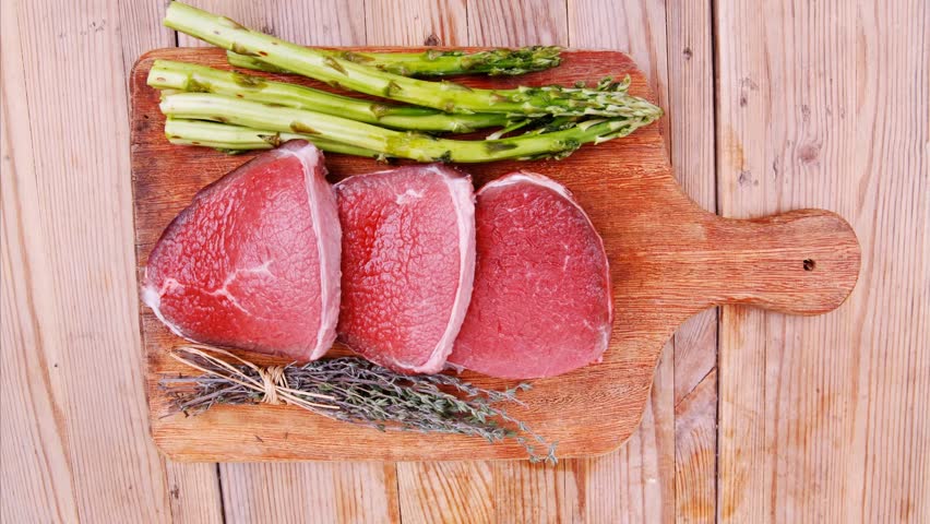 food beef fillet on cutting board with food beef fillet on cutting board with