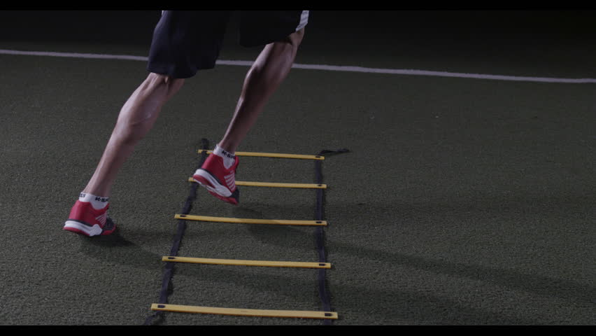 A Man Does Ladder Running Drills And Exercises Outside On