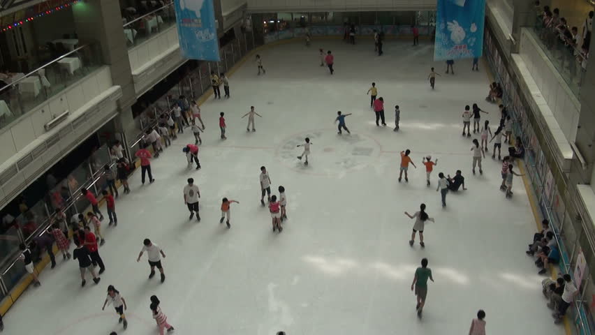 GUANGZHOU - AUGUST 9 2010: People Are Skating On An Indoor Ice Rink In