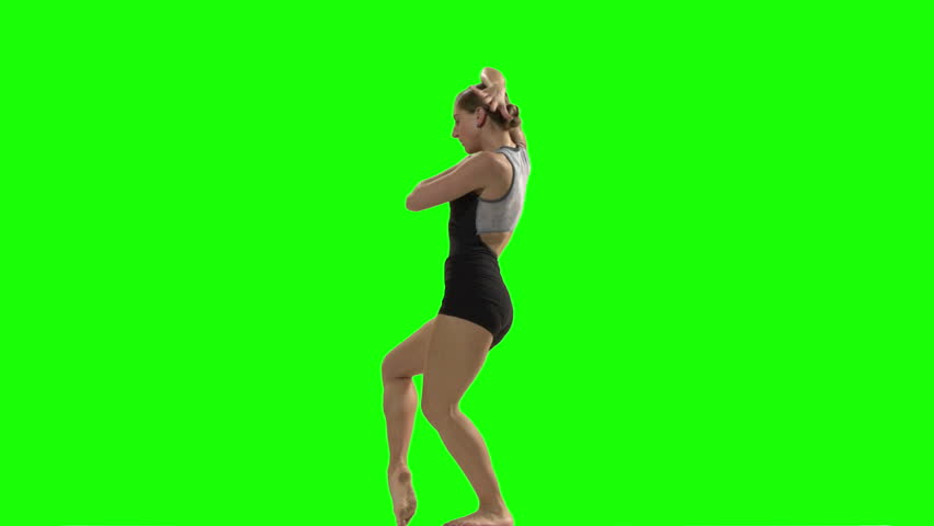 Young Woman Doing A Modern Dance Piece In Front Of Green Screen Stock