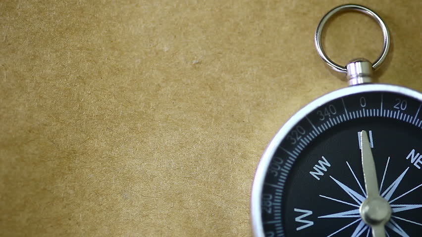 Up Of Compass On Brown Background A Silver And Black Compass On A Brown Background Stock