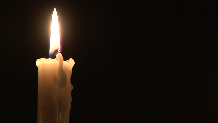 Loop With Single Simple White Candle And Flickering Flame Against A Black Background With