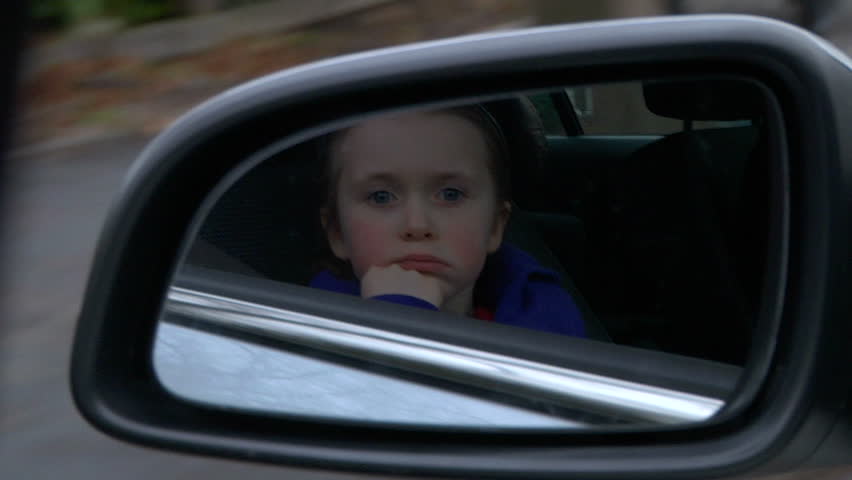 Little Girl Bored In Car Staring Into Space Through Window Stock