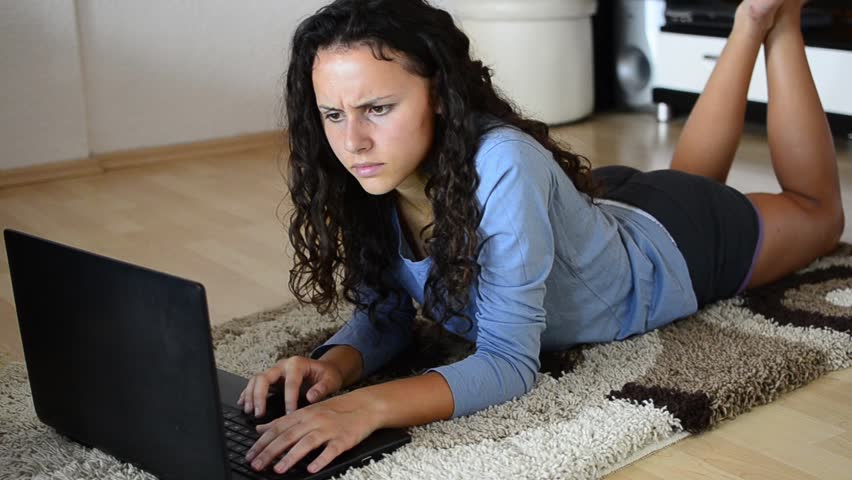 Beautiful Young Teen Girl Laying In Living Room With Laptop Stock