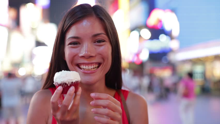 Woman Eating Cupcake In New York On Times Square Manhattan Cute Girl Eating Unhealthy Cupcakes