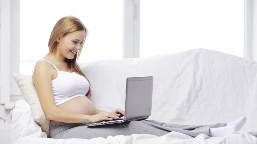 Smiling Beautiful Woman Working On Her Laptop In Bed While ...