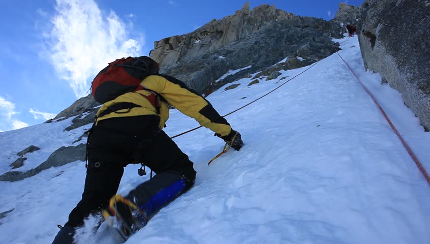 Mountaineer Climbs A Steep Iced Mountain. Mont Blanc, France. Stock