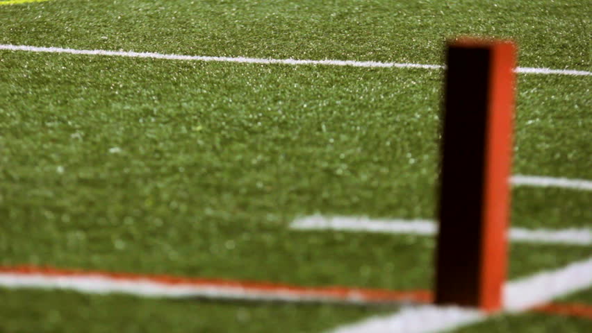 Rack Focus To An End Zone Pylon On A Football Field. Stock Footage