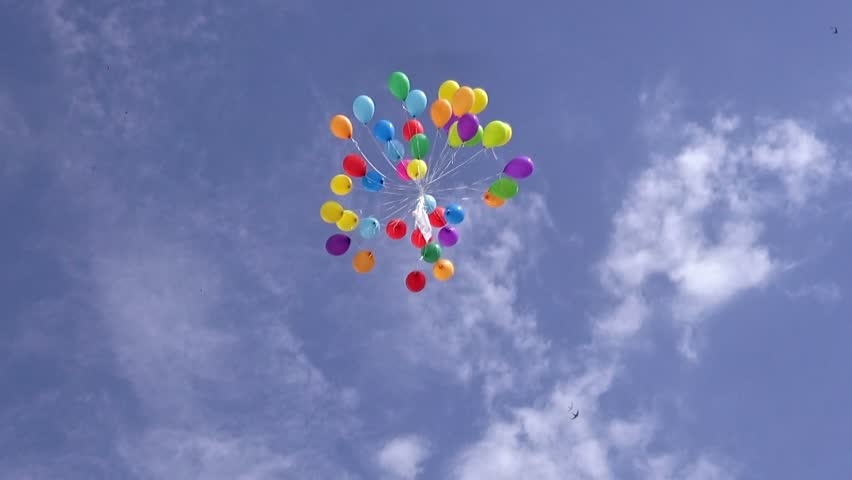 A Bunch Of Colourful Helium Filled Balloons Tied Together Flying ...