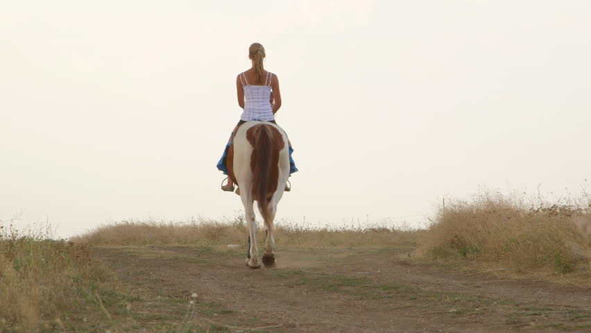 Young Girl Riding Horse In Countryside Rear View Stock Footage Video