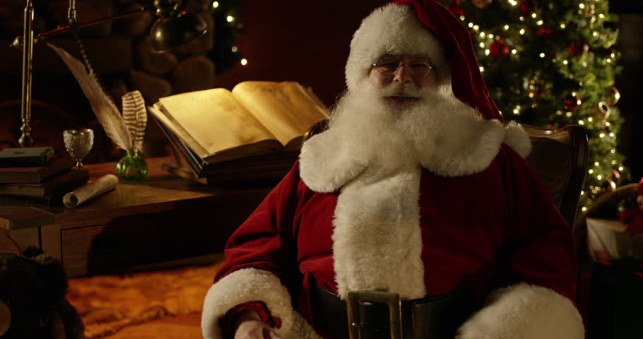 Santa Claus Sitting By Fireplace Looking At List Stock Footage Video ...