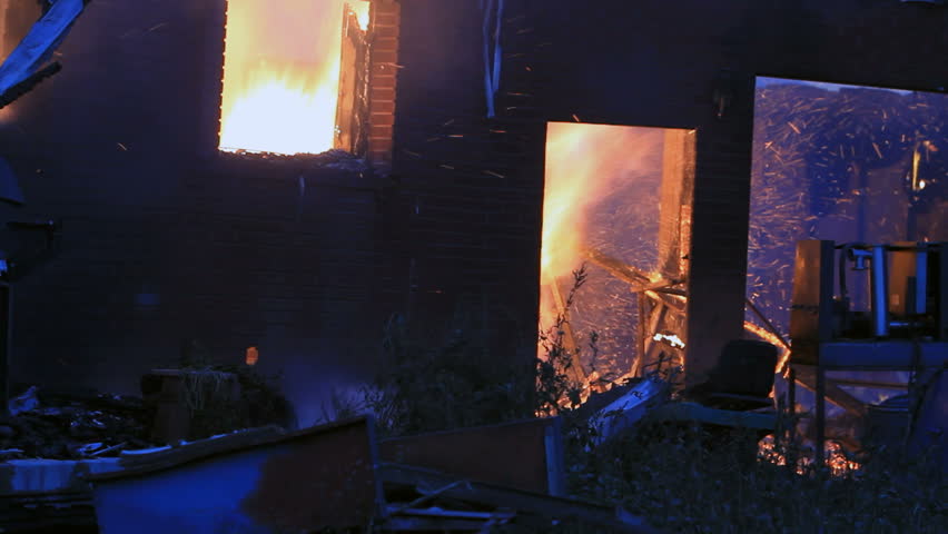 Home On Fire After Dark With Sparks, Flames And Smoke Inside Structure ...