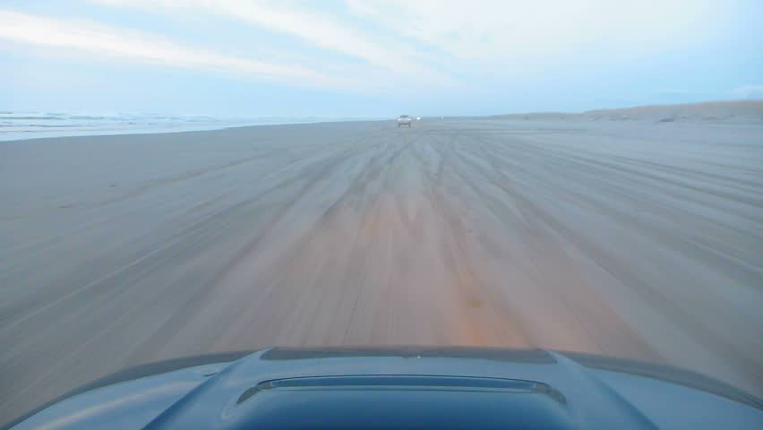 Cars Driving On Sandy Beach Next To The Pacific Ocean In Long Beach ...