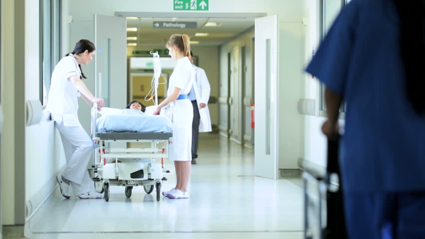 Medical Staff Transfer Patients Between Hospital Wards By Wheelchair ...