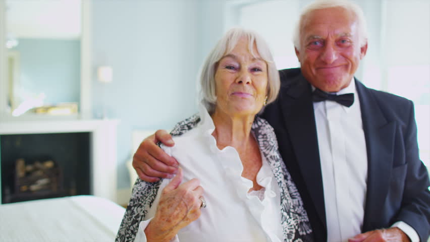 Attractive Senior Couple In Formal Evening Wear Share A Kiss As They ...