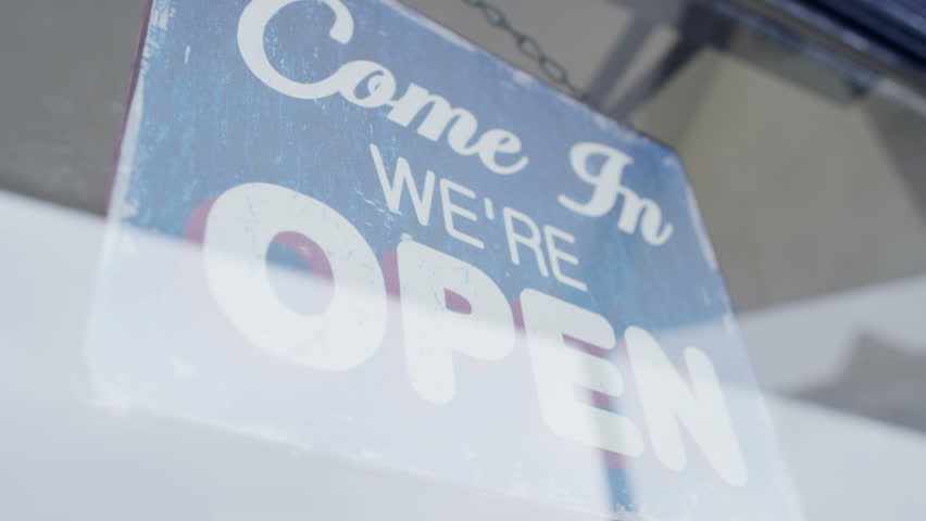 'Open' Sign Is Turned To 'Closed' In A Storefront Window Stock Footage ...