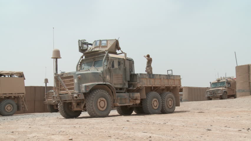 Pan Shot Of Parked MRAP To Another MRAP Pushing A Minesweeper Stock ...