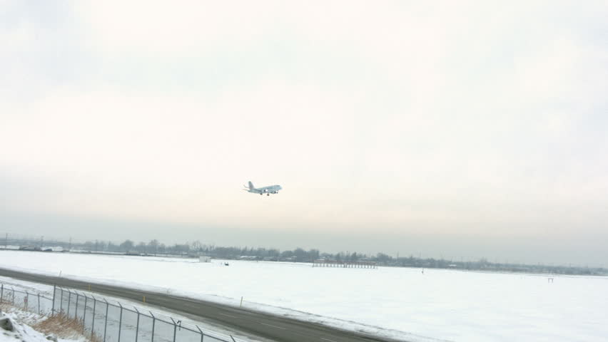 Plane Descending For Landing At Airport Runway In The Winter With Snow ...