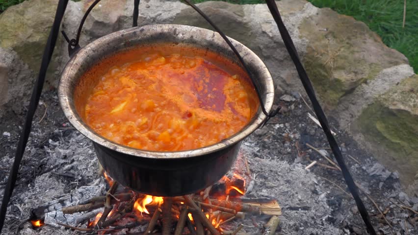 A Medieval Reenactor Stirring A Cauldron Of Food Over A Fire Stock ...