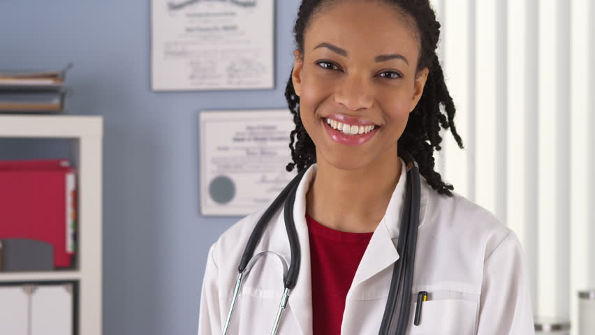 Close Up Portrait Of Black Female Doctor Smiling In Medical Clinic ...