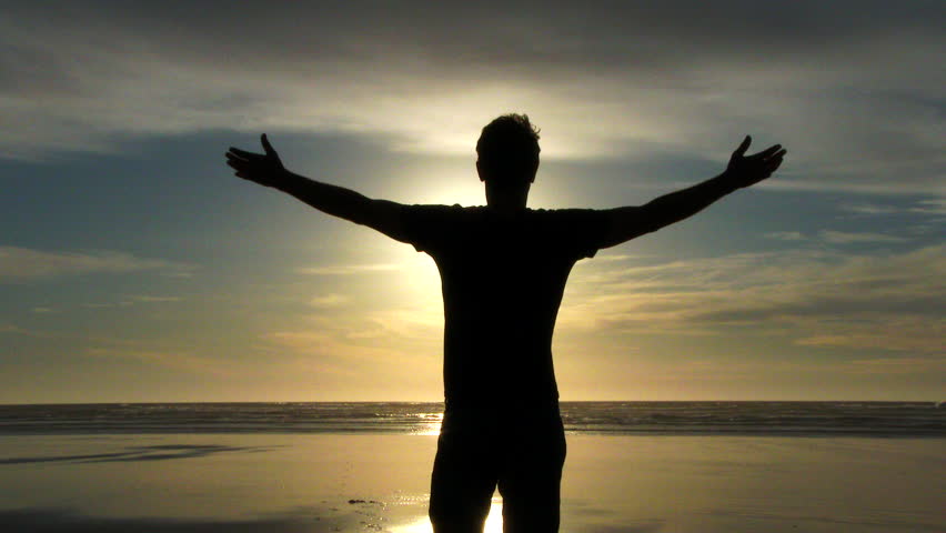 Model Released Person Standing With Arms Up In The Air On Sandy Beach ...